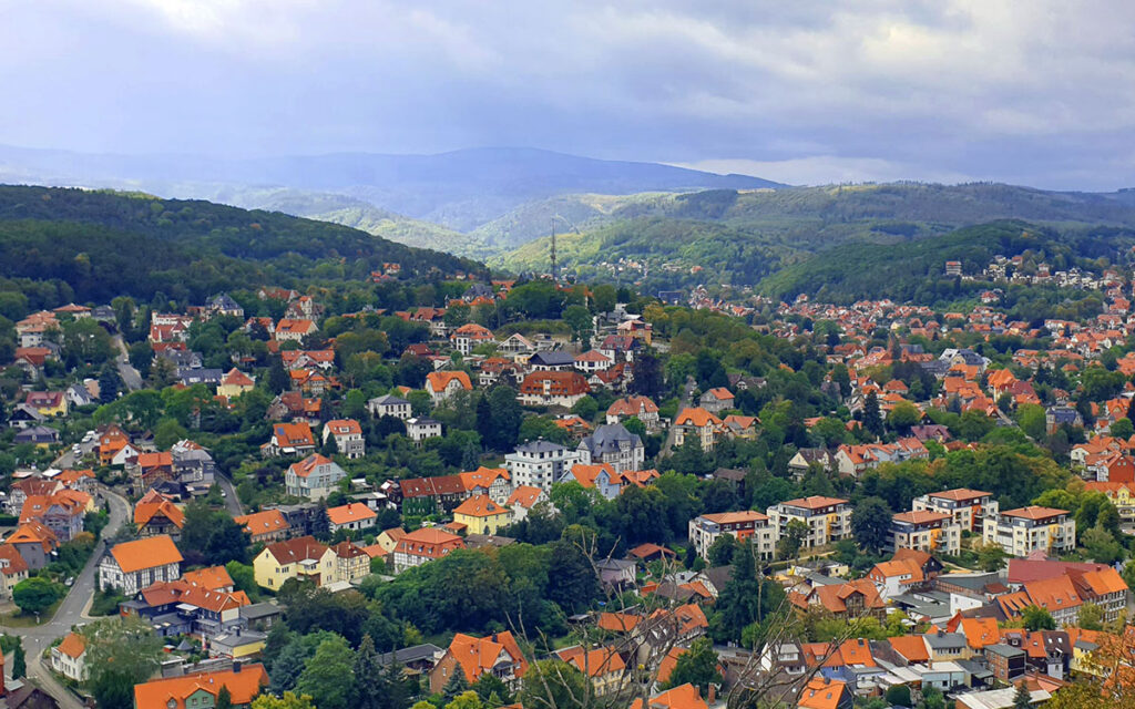 Panoramablick von der Schlossterrasse Wernigerode über die roten Dächer der Stadt und die bewaldeten Hügel des Harzes